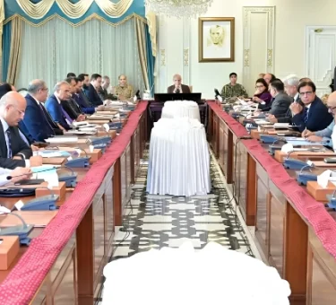 Government officials and ministers seated around a long conference table in Islamabad, discussing the extension of austerity measures and revised business hours until June 30, 2026.