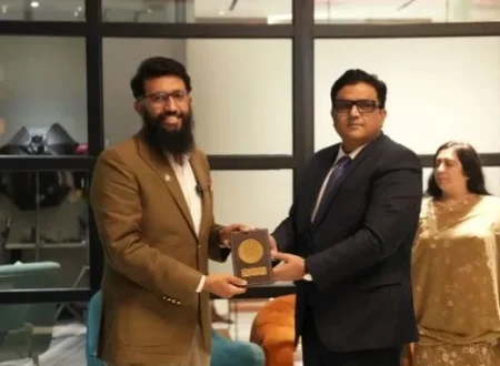 Devsinc representative receives a commemorative shield during the National Institute of Public Administration delegation visit in Lahore.