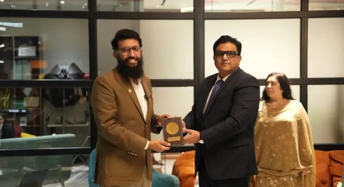 Devsinc representative receives a commemorative shield during the National Institute of Public Administration delegation visit in Lahore.
